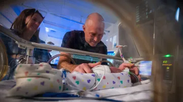 Mom and dad holding premature son